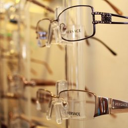 up close photo of two pairs of glasses hanging on a display wall