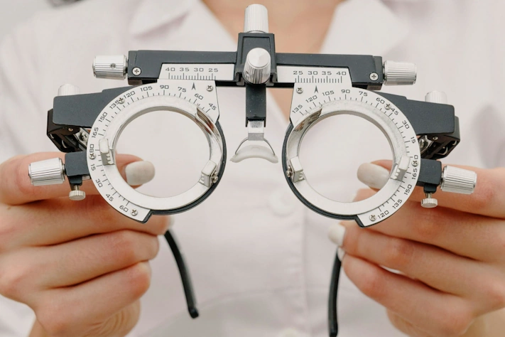 photo of an optometrist holding a pair of glasses optometry tool